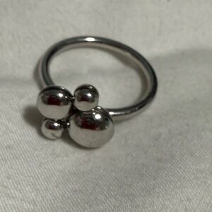 Calvin Klein Silver tone dog paw shaped Spinner Ring. FULL INCLUSION. Size 7